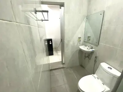 a bathroom with a toilet and a sink at Bidadari Homestay Nusa Dua in Nusa Dua