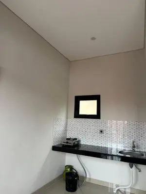 a bathroom with a sink and a mirror on the wall at Kubu Gandi Homestay in Denpasar