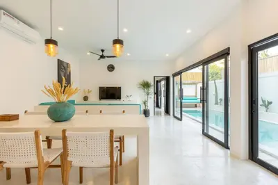 a dining room with a table and chairs at Aaryan Villa 1 in Seminyak