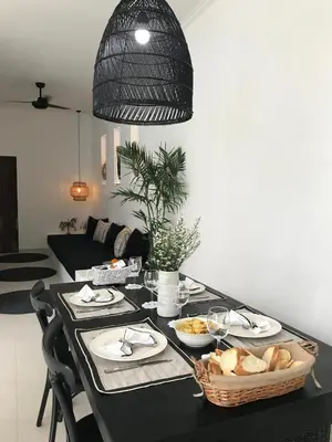 a table with plates of food and a basket of bread at Villa Casa Leo in Seminyak