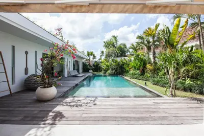 a swimming pool in the backyard of a house at Villa Hugo in Canggu