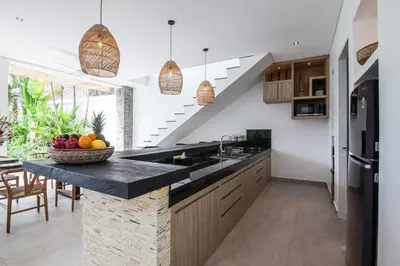 a kitchen with a counter with a bowl of fruit at Villa Hugo in Canggu