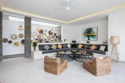 a living room with a couch and a table at Villa Hugo in Canggu