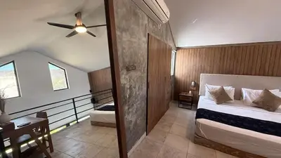 a bedroom with a bed and a ceiling fan at Ambara Villa - Quiet Luxury in Umalas in Canggu