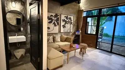 a living room with a couch and a sink at Ambara Villa - Quiet Luxury in Umalas in Canggu