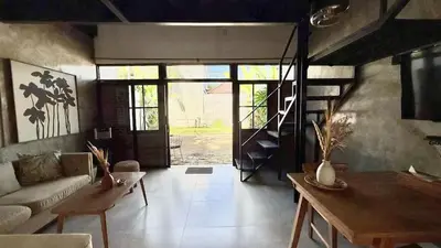 a living room with a couch and a table at Ambara Villa - Quiet Luxury in Umalas in Canggu