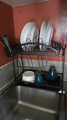a drying rack with plates and utensils on a kitchen sink at Classic Balinese Stay Jayakarta - 5 min walk to Kuta beach AC WiFi ! in Kuta