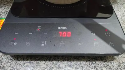 a close up of a digital clock on a stove at Classic Balinese Stay Jayakarta - 5 min walk to Kuta beach AC WiFi ! in Kuta