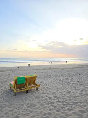 a couple of beach chairs sitting on the beach at Classic Balinese Stay Jayakarta - 5 min walk to Kuta beach AC WiFi ! in Kuta