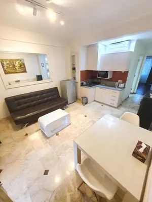 a living room with a couch and a table at Classic Balinese Stay Jayakarta - 5 min walk to Kuta beach AC WiFi ! in Kuta