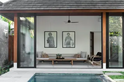 a living room with a couch and a pool at Villa Under the Sun - Seminyak in Seminyak