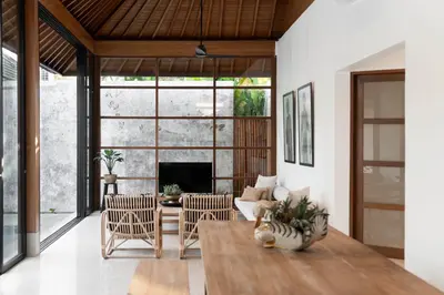 a living room with a fireplace and a table at Villa Under the Sun - Seminyak in Seminyak