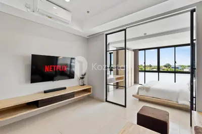 a bedroom with a tv and a bed at Sariha by Kozystay - Nusa Dua in Nusa Dua
