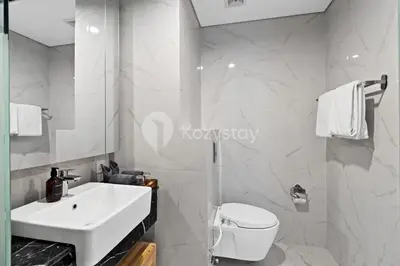 a white bathroom with a sink and a toilet at Sariha by Kozystay - Nusa Dua in Nusa Dua
