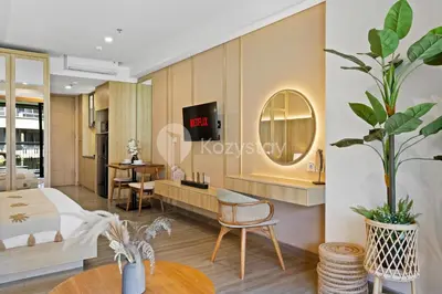 a living room with a bed and a table at Rivana by Kozystay - Nusa Dua in Nusa Dua