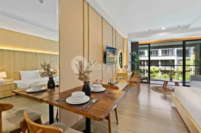 a living room with a table and a couch at Rivana by Kozystay - Nusa Dua in Nusa Dua
