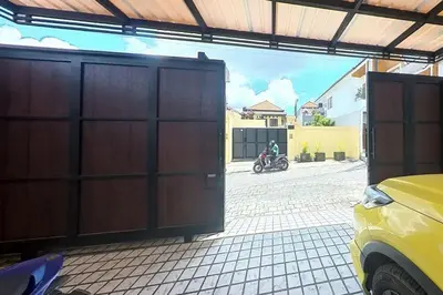 an open garage door with a motorcycle in a driveway at Villa 9 in Seminyak