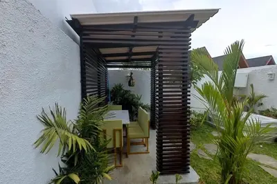 a patio with a table and chairs under awning at Villa 9 in Seminyak