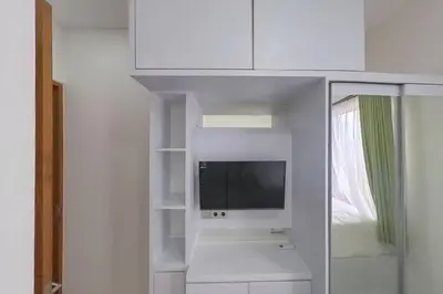 a white cabinet with a tv in a room at Villa 9 in Seminyak