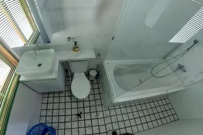 a bathroom with a tub and a toilet and a sink at Villa 9 in Seminyak