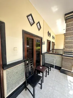 a waiting room with chairs and a counter at OSA Guest House in Seminyak