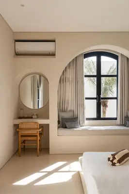 a bedroom with a window and a bed and a mirror at Brand New Exquisite Luxury 5 BR Villa Umalas in Kerobokan
