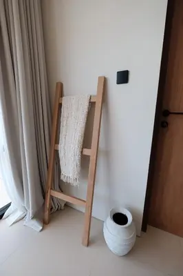 a wooden easel sitting in a room next to a window at Brand New Exquisite Luxury 5 BR Villa Umalas in Kerobokan