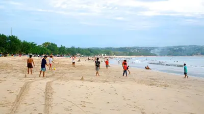 a group of people playing soccer on the beach at Zen Home in Jimbaran