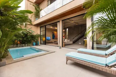 a house with a swimming pool and a building at DUNE ARRAKIS villas in Seminyak