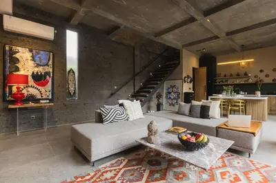 a living room with a couch and a table at DUNE ARRAKIS villas in Seminyak