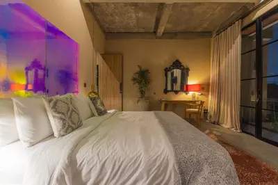 a bedroom with a white bed and a table at DUNE ARRAKIS villas in Seminyak