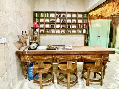 a kitchen with a large wooden table and chairs at LAVENDER STAR HOUSE h in Kuta