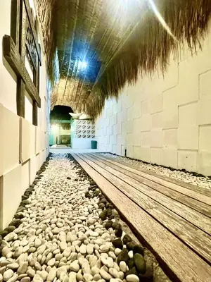 a hallway of a building with rocks on the floor at LAVENDER STAR HOUSE h in Kuta