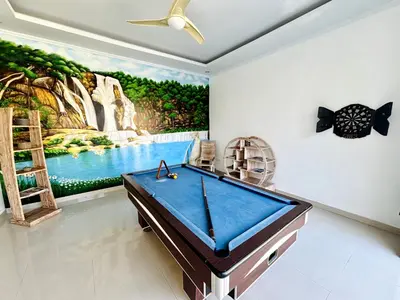 a pool table in a room with a painting at Villa Ohana 2 BR Family villa with pool in Umalas in Kerobokan