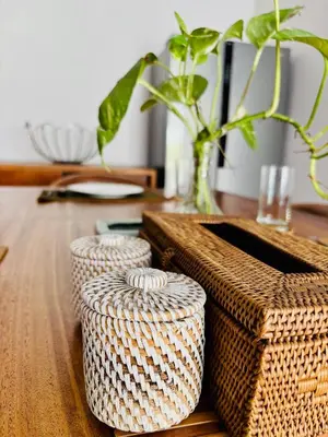 two wicker baskets on a wooden table with a vase at Villa Ohana 2 BR Family villa with pool in Umalas in Kerobokan