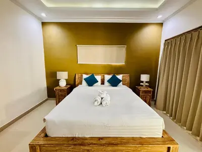 a bedroom with a bed with two towels on it at Villa Ohana 2 BR Family villa with pool in Umalas in Kerobokan