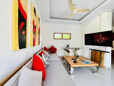 a living room with a couch and a table at Villa Ohana 2 BR Family villa with pool in Umalas in Kerobokan