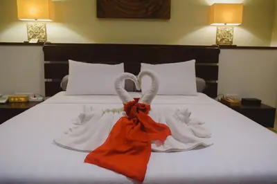 a bedroom with a bed with towels on it at Luxury Apartment at AYANA Residences in Jimbaran