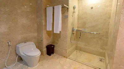 a bathroom with a toilet and a shower at Luxury Apartment at AYANA Residences in Jimbaran