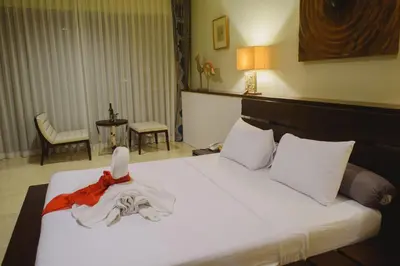 a bedroom with a bed with a costume on it at Luxury Apartment at AYANA Residences in Jimbaran