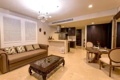 a living room with a couch and a table at Luxury Apartment at AYANA Residences in Jimbaran