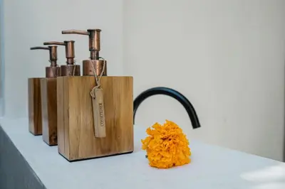 a group of three wooden bottles sitting on a table at Villa Kanan Seminyak - Stylish 2BR Villa Private Pool in Seminyak