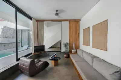 a living room with a couch and a tv at Villa Kanan Seminyak - Stylish 2BR Villa Private Pool in Seminyak