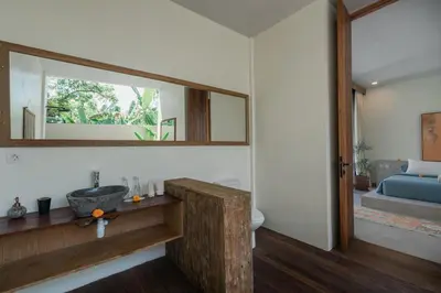 a bathroom with a sink and a mirror at Villa Kanan Seminyak - Stylish 2BR Villa Private Pool in Seminyak