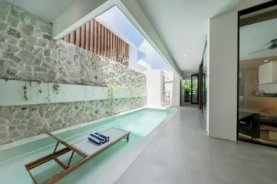 a swimming pool in the middle of a house at Villa Kiri - Modern 2BR Hideaway Rooftop & Private Pool in Seminyak