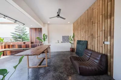 a living room with a wooden table and a couch at Villa Kiri - Modern 2BR Hideaway Rooftop & Private Pool in Seminyak