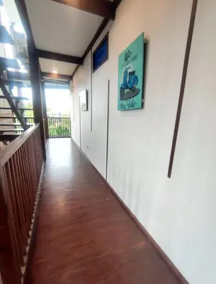 a hallway of a building with a sign on the wall at Bashania in Kerobokan