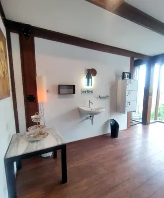 a living room with a sink and a table at Bashania in Kerobokan