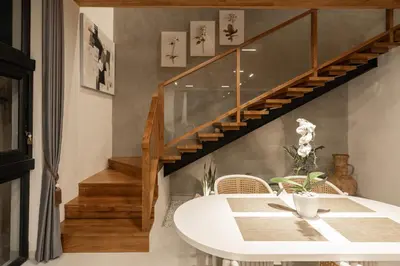 a dining room with a table and a staircase at Ben's Villa 1 by Alfred in Bali in Kerobokan