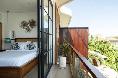 a bedroom with a bed on a balcony at Ben's Villa 1 by Alfred in Bali in Kerobokan